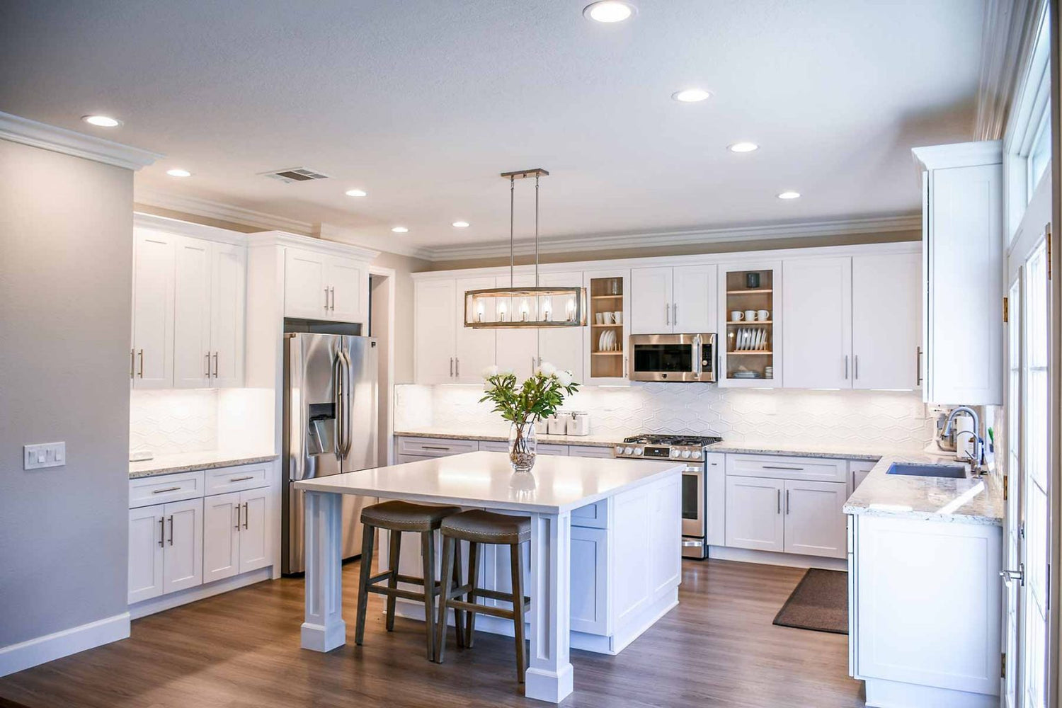 Luxury U-shaped modular kitchen with Laminated finish, built using high-density moisture-resistant (HDMR) boards and glossy acrylic sheet cabinetry, offering maximum storage, seamless workflow, and an eco-friendly, modern aesthetic.